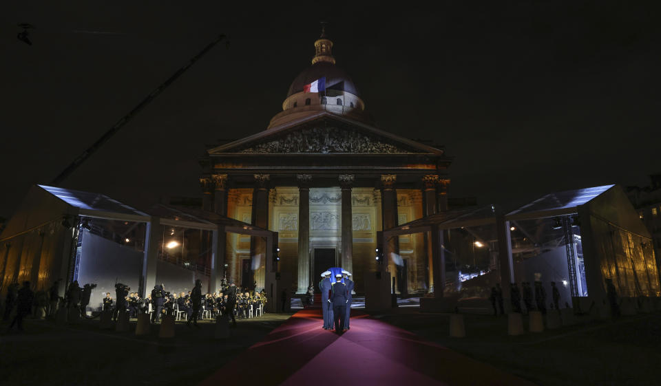 Six carriers of the Air Force and Space carry the cenotaph of Josephine Baker, covered with the French flag, into the Pantheon in Paris, France, Tuesday, Nov. 30, 2021, where she is to symbolically be inducted, becoming the first Black woman to receive France's highest honor. Her body will stay in Monaco at the request of her family. (Thomas Coex/Pool Photo via AP)