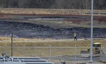 In this Wednesday, Feb. 5, 2014 photo, shows a coal ash pond at the Dan River Power Plant in Eden, N.C. Duke Energy estimates that up to 82,000 tons of ash from the pond has been released from a break in a 48-inch storm water pipe into the Dan River. (AP Photo/Gerry Broome)