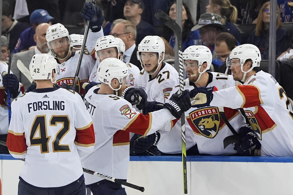 Florida Panthers center Sam Bennett (9) is congratulated by teammates after scoring against the New York Rangers during the third period of Game 1 of the NHL hockey Eastern Conference Stanley Cup playoff finals, Wednesday, May 22, 2024, in New York. (AP Photo/Julia Nikhinson)