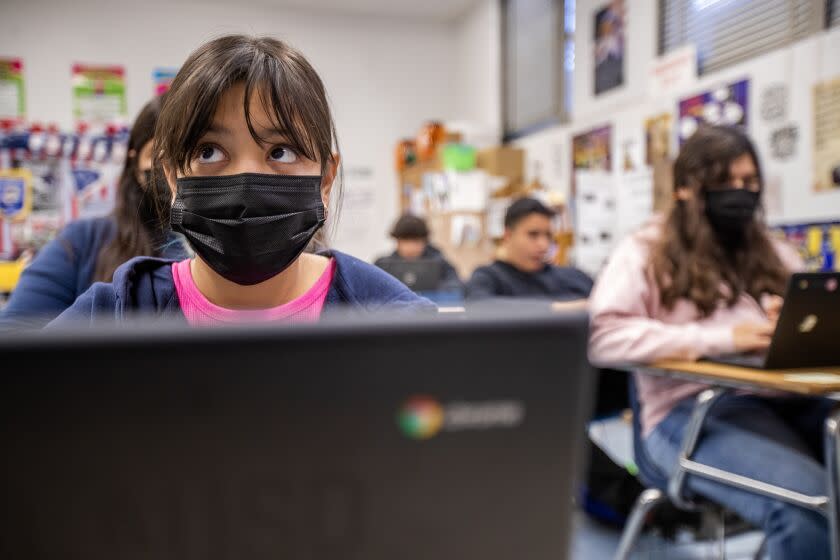 Los Angeles, CA - April 04: After losing three days of instruction from the LAUSD strike, eighth-grader Estrella Ruiz, left, 13, listens to her teacher in the 7th/8th grade English and Social Studies as she joins fellow students participating in "acceleration days," which are intended as an opportunity for needed but optional extended learning for all students in the nation's second-largest school system at Griffith STEAM Magnet Middle School in Los Angeles Tuesday, April 4, 2023. (Allen J. Schaben / Los Angeles Times)