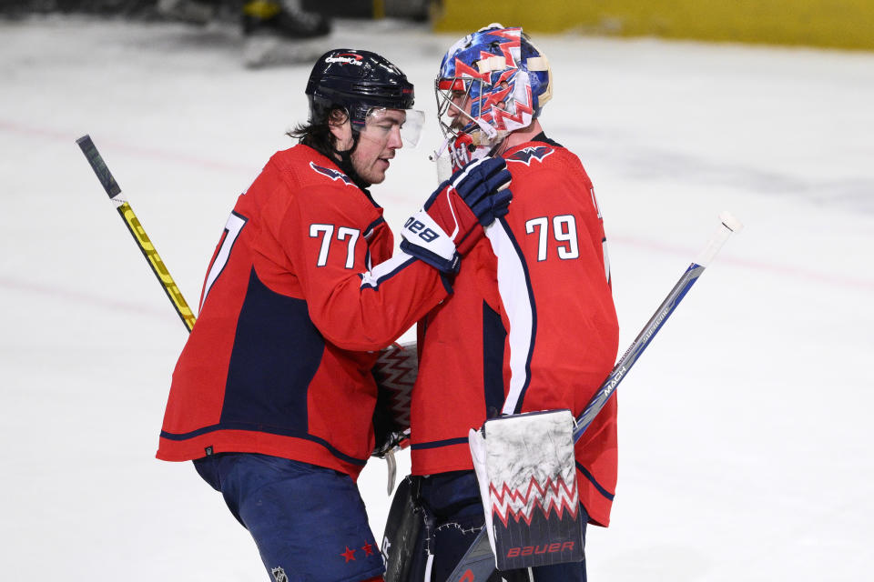 Washington Capitals right wing T.J. Oshie (77) and goaltender Charlie Lindgren (79) celebrate the team's win in an NHL hockey game against the St. Louis Blues, Thursday, Jan. 18, 2024, in Washington. (AP Photo/Nick Wass)