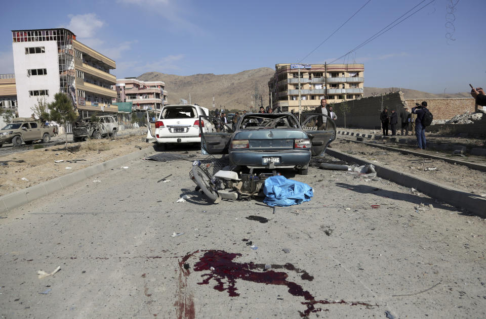 Blood stains the ground after a car bomb attack in Kabul, Afghanistan, Wednesday, Nov. 13, 2019. A car bomb detonated in the Afghan capital during Wednesday's morning commute, killing seven people and wounding at least seven, officials said. (AP Photo/Rahmat Gul)