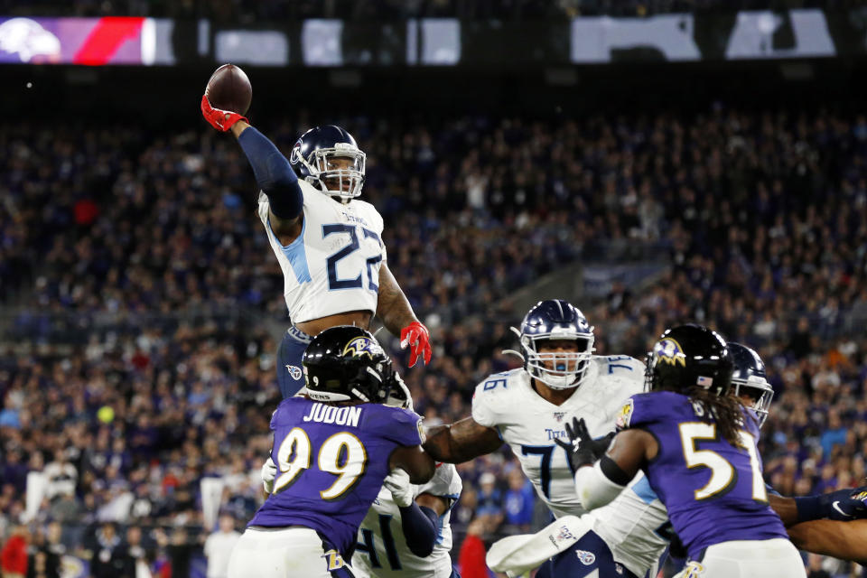 Derrick Henry throws a touchdown pass to Corey Davis in the Tennessee Titans' divisional round victory over the Baltimore Ravens. Henry's high school coach told Yahoo Sports he ran a nearly identical play almost a decade ago. (Todd Olszewski/Getty Images)