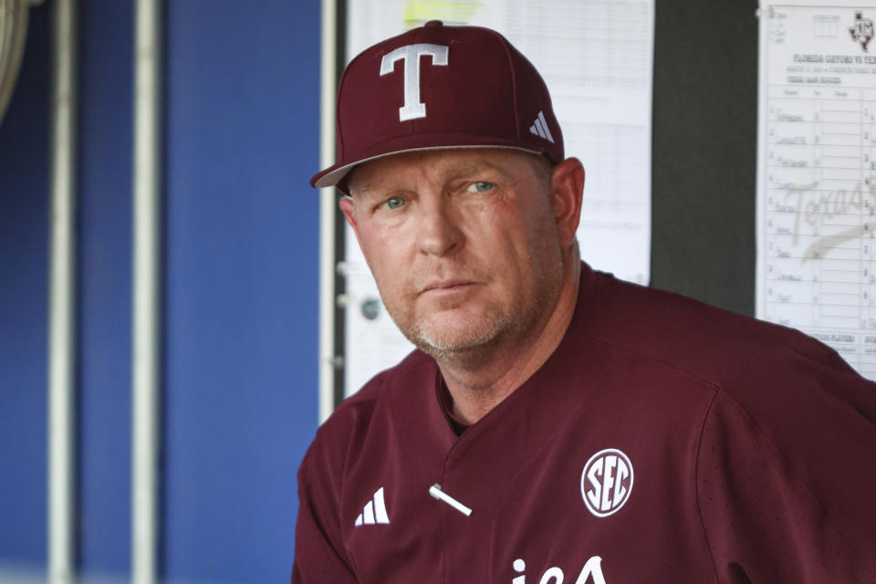 FILE - Texas A&M head coach Jim Schlossnagle watches warm-ups before an NCAA baseball game against Florida on Saturday, March 16, 2024, in Gainesville, Fla. exas A&M will play Tennessee in the best-of-three College World Series final beginning Saturday night in Omaha, Nebraska. Both teams are seeking their first national championship in baseball. (AP Photo/Gary McCullough, File)