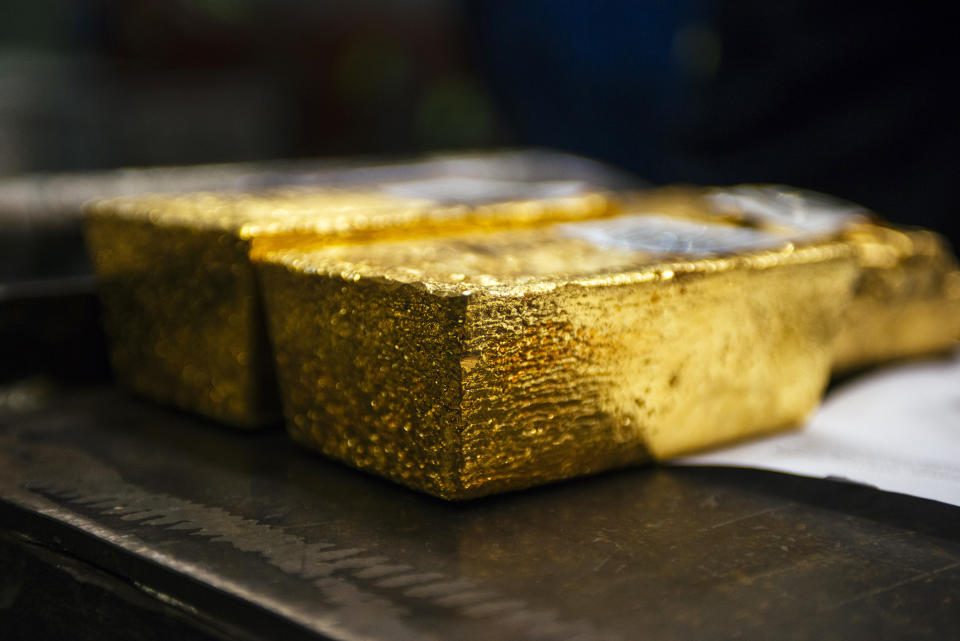 Gold bullion bars sit following casting at a refinery in Germiston, South Africa. Photographer: Waldo Swiegers/Bloomberg