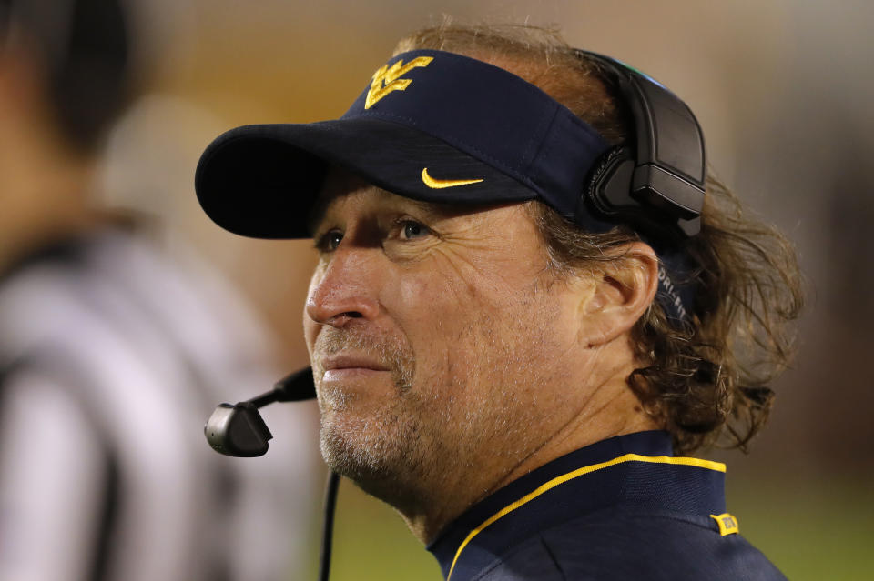 West Virginia head coach Dana Holgorsen watches from the sideline during the second half of an NCAA college football game against Iowa State, Saturday, Oct. 13, 2018, in Ames, Iowa. (AP Photo/Charlie Neibergall)