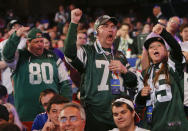 New York Jets fans react to the Jets' third round pick, Dexter McDougal of Maryland, during the 2014 NFL Draft, Friday, May 9, 2014, in New York. (AP Photo/Jason DeCrow)