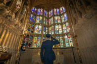 Flying Officer James Buckingham salutes The Battle of Britain memorial window inside Westminster Abbey, the stained glass window by Hugh Easton that contains the badges of the fighter squadrons that took part in the Battle, during a service to mark the 80th anniversary of the Battle of Britain at Westminster Abbey, London, Sunday, Sept. 20, 2020. (Aaron Chown/Pool Photo via AP)