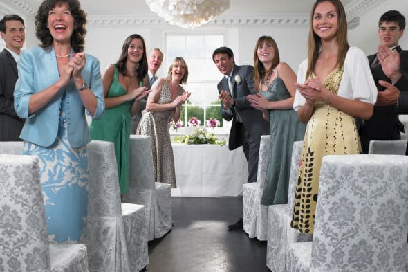 Wedding guests looking down aisle