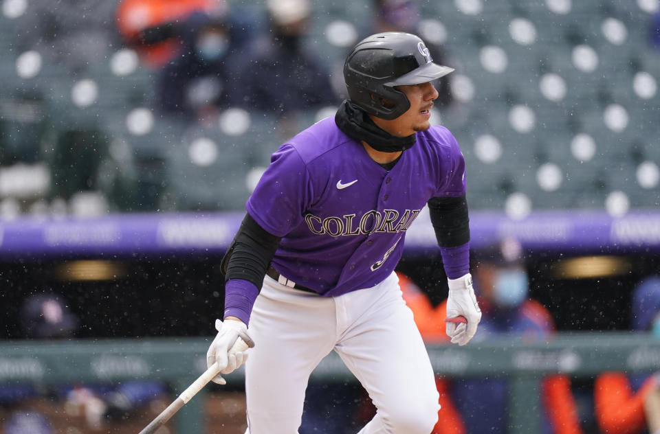 Colorado Rockies' Dom Nunez follows the flight of his RBI-single off Houston Astros starting pitcher Jose Urquidy in the second inning of a baseball game Wednesday, April 21, 2021, in Denver. (AP Photo/David Zalubowski)