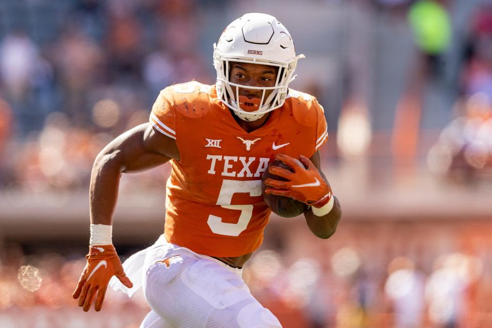 Texas running back Bijan Robinson (5) looks for more yards against Oklahoma State during the first half of an NCAA college football game in Austin, Saturday, Oct., 16, 2021.