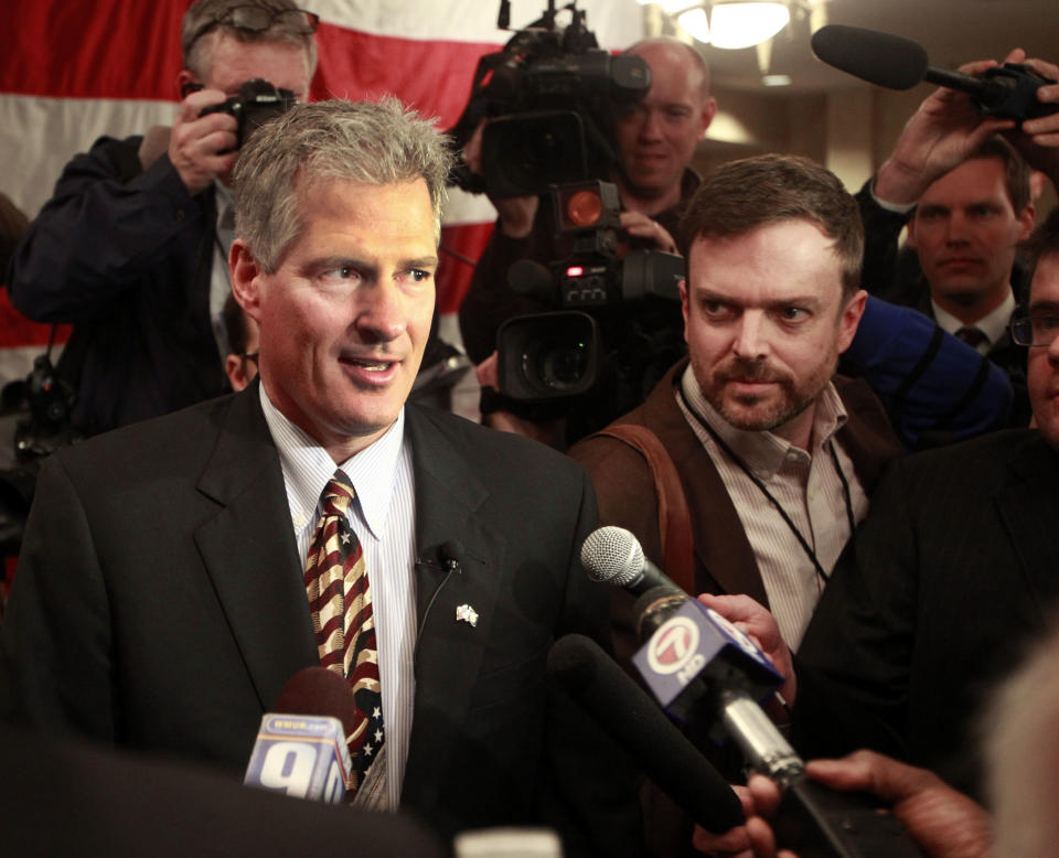 Former Massachusetts U.S. Senator Scott Brown, left, walks into a crowd of supporters after announcing his plans to run for U.S. Senator in New Hampshire Thursday, April 10, 2014 in Portsmouth, N.H. Brown hopes to unseat U.S. Sen. Jeanne Shaheen, D-N.H. (AP Photo/Jim Cole)