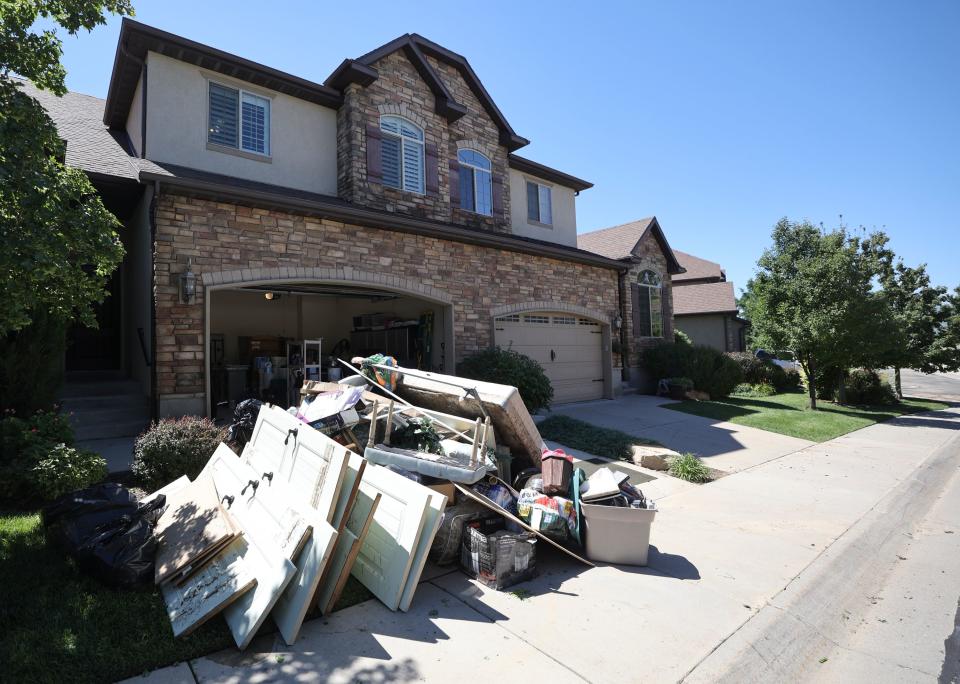 Damaged furniture and belongings are piled up outside of a house in Draper after flooding and mudslides on Friday, Aug. 4, 2023. Draper Mayor Troy Walker declared a state of emergency due to flooding. | Kristin Murphy, Deseret News