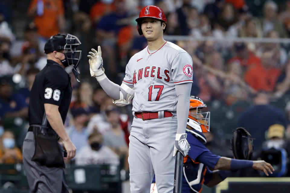 Los Angeles Angels designated hitter Shohei Ohtani (17) reacts to umpire Ryan Blakney (36) after getting called out on strikes as Houston Astros catcher Martin Maldonado, right, returns the ball during the first inning of a baseball game Sunday, April 25, 2021, in Houston. (AP Photo/Michael Wyke)