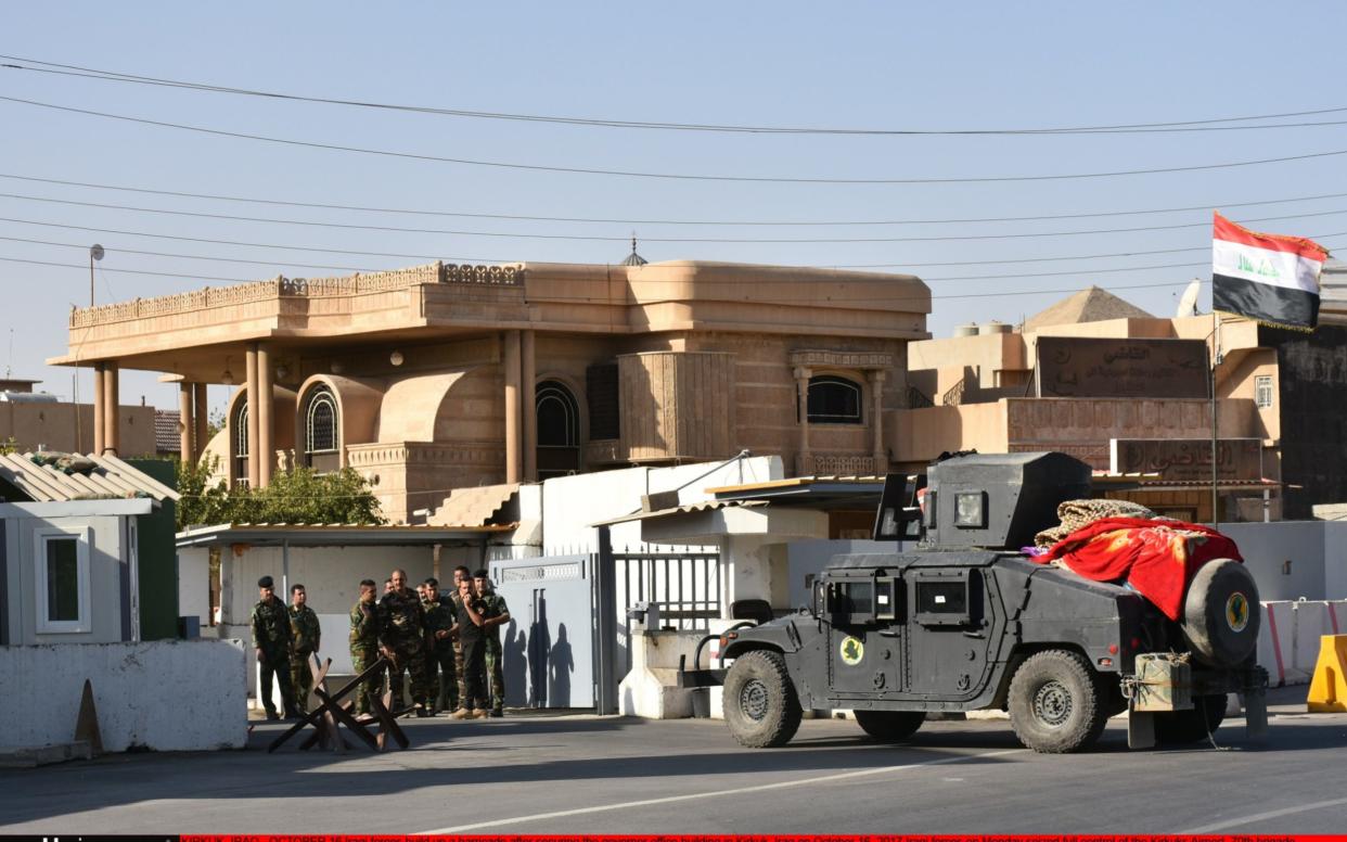 Iraqi armed forces construct a barricade around the governor's building shortly after seizing the office. - Anadolu