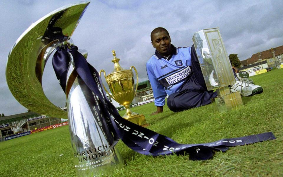 Mark Alleyne, Captain of Gloucestershire, poses with the Norwich Union NCL trophy, the Benson and Hedges Cup and the NatWest Trophy in 2000 - Mike Finn-Kelcey/ALLSPORT via GETTY IMAGES