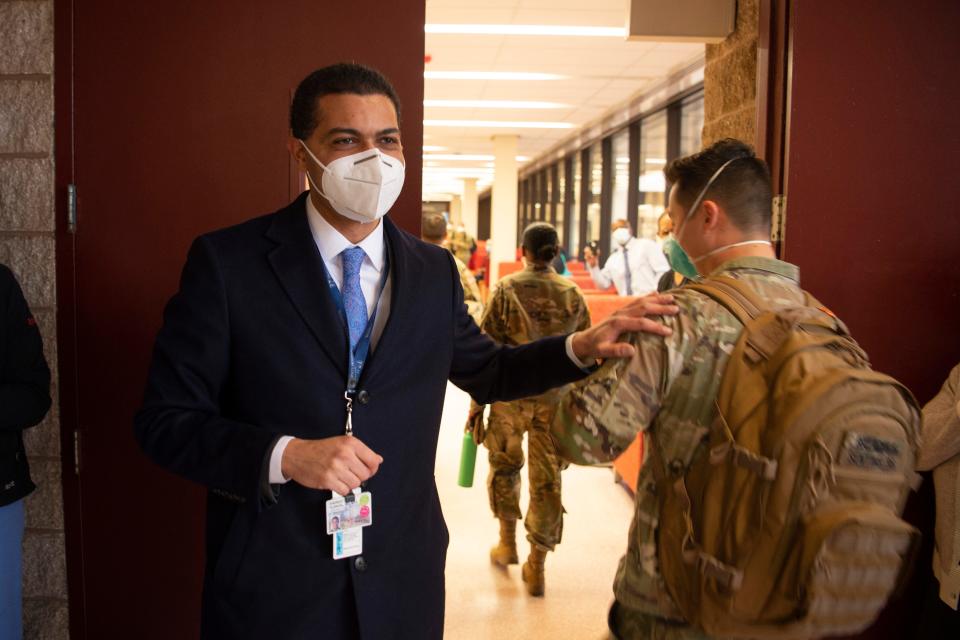 At left, Dr. Shereef Elnahal, University Hospital President and CEO, welcomes 23 military medical support team members in Newark, N.J. on Thursday Jan. 20, 2022. The military personnel will serve as temporary reinforcements to the hospitalÕs clinical staff. 