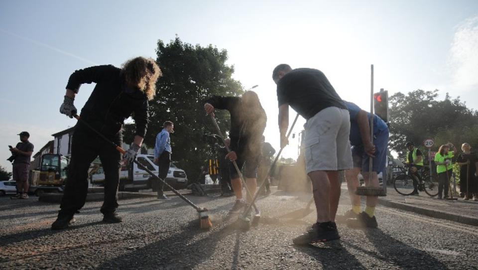 Volunteers in Southport came out to clean up the devastation on Wednesday morning after far-right protesters clashed with police outside a mosque (PA)