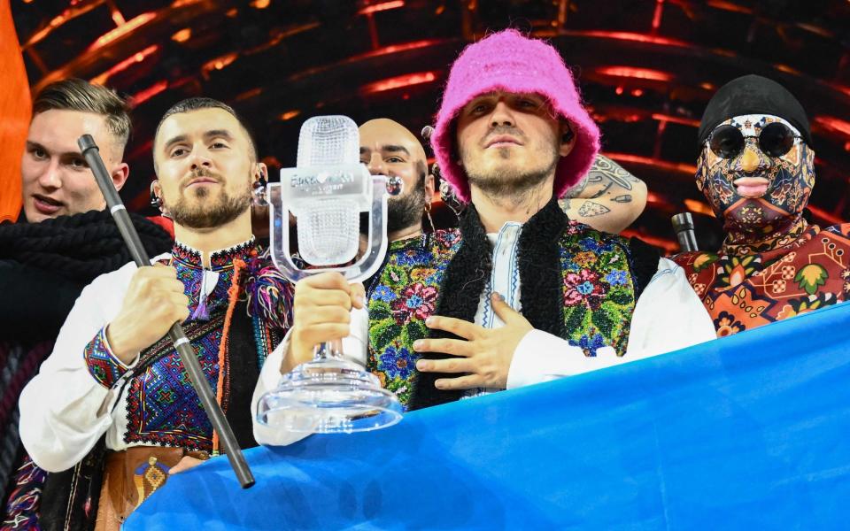 Members of the band "Kalush Orchestra" pose onstage with the winner's trophy and Ukraine's flags after winning on behalf of Ukraine the Eurovision Song contest 2022 on May 14, 2022 at the Pala Alpitour venue in Turin. (Photo by Marco BERTORELLO / AFP) (Photo by MARCO BERTORELLO/AFP via Getty Images) - MARCO BERTORELLO/AFP via Getty Images