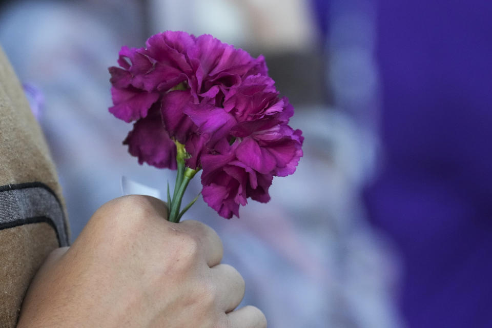 A purple flower is seen during a vigil in honor of 11-year-old Audrii Cunningham, Wednesday, Feb. 21, 2024, in Livingston, Texas. Cunningham's family reported her missing Thursday, Feb. 15, when she failed to return to her Livingston home after school. On Tuesday, Feb. 20, search teams found her body in the Trinity River in a rural area north of Houston about 10 miles (16 kilometers) from her home, according to the capital murder criminal complaint filed Tuesday against Don Steven McDougal, a family friend accused of killing the young girl. (Jason Fochtman/Houston Chronicle via AP)