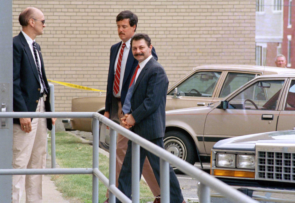 FILE - In this June 22, 1988 file photo, Georges Younan, right, one of three defendants of Lebanese descent from Montreal, Canada, is led into federal court in handcuffs in Burlington, Vt. Younan and the two others were caught smuggling the makings of a bomb into the U.S., on Oct. 23, 1987, in Richford, Vt. All three were convicted and sent to federal prison. (AP Photo/Toby Talbot, File)