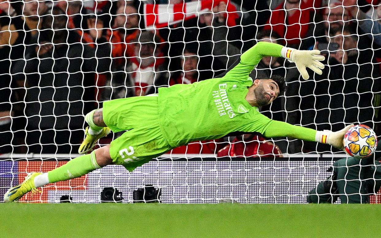 David Raya of Arsenal saves the second penalty from Wendell of FC Porto (not pictured) in the penalty shoot out during the UEFA Champions League 2023/24 round of 16 second leg match between Arsenal FC and FC Porto at Emirates Stadium on March 12, 2024 in London, England