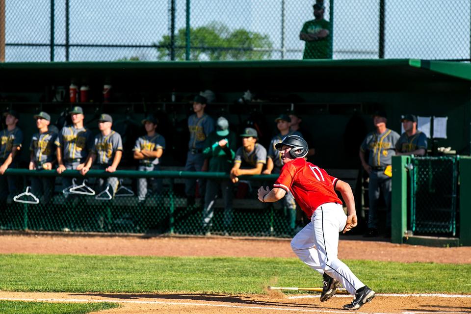 Western Dubuque's Brett Harris runs to first base after getting a hit against Cedar Rapids Kennedy on May 30 in Farley.