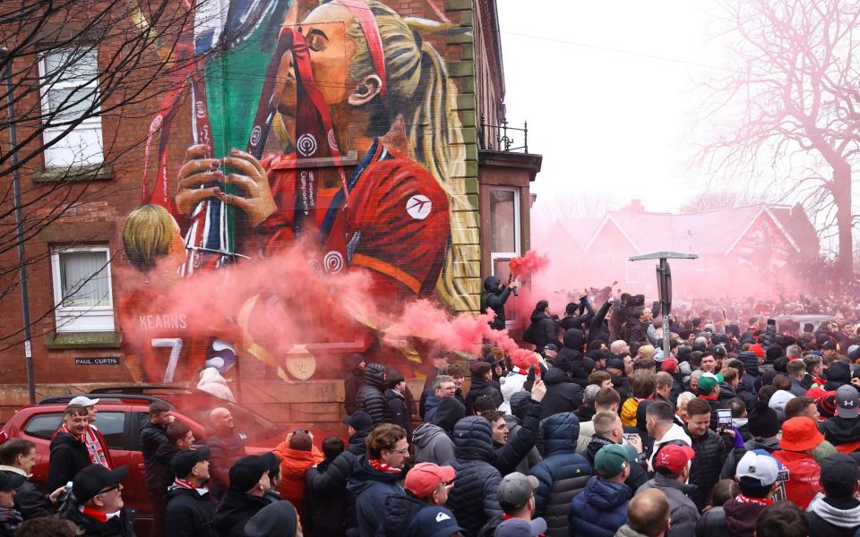 Liverpool fans let off smoke flares outside the stadium before the match