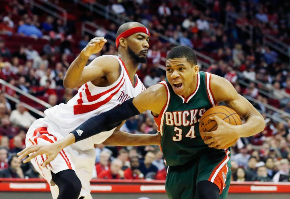 HOUSTON, TX - FEBRUARY 06:  Giannis Antetokounmpo #34 of the Milwaukee Bucks drives with the ball against Corey Brewer #33 of the Houston Rockets during their game against the Milwaukee Bucks at the Toyota Center on February 6, 2015 in Houston, Texas. NOTE TO USER: User expressly acknowledges and agrees that, by downloading and/or using this photograph, user is consenting to the terms and conditions of the Getty Images License Agreement.  (Photo by Scott Halleran/Getty Images)