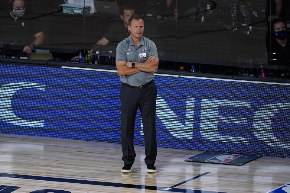 Washington Wizards head coach Scott Brooks watches his team play against the Philadelphia 76ers during the first half of an NBA basketball game Wednesday, Aug. 5, 2020 in Lake Buena Vista, Fla. (AP Photo/Ashley Landis)