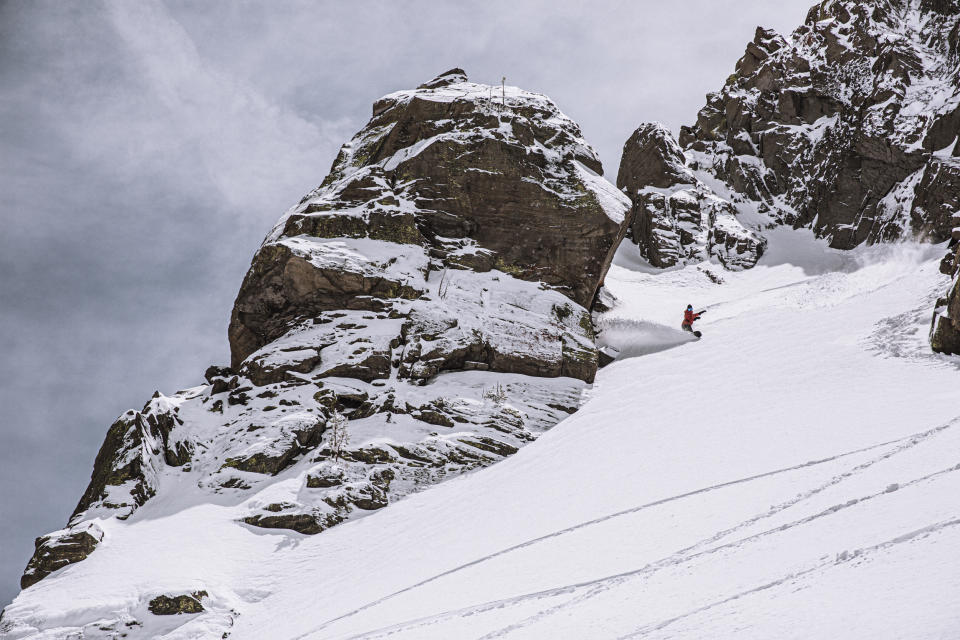 This May 17, 2019 photo provided by the Mammoth Mountain ski area shows a snowboarder making his way downhill in fresh snow at Mammoth Mountain ski area. Late spring wintry weather has brought rain, wind and snow to California, including a dusting of white on mountain peaks east of Los Angeles.(Peter Morning/Mammoth Mountain ski area via AP)