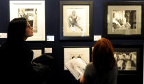 Potential bidders look at Marylin Monroe photos prior to an auction of pictures by the late celebrity photographer Milton H. Greene, in Warsaw, Poland, Thursday, Nov. 8, 2012. (AP Photo/Alik Keplicz)