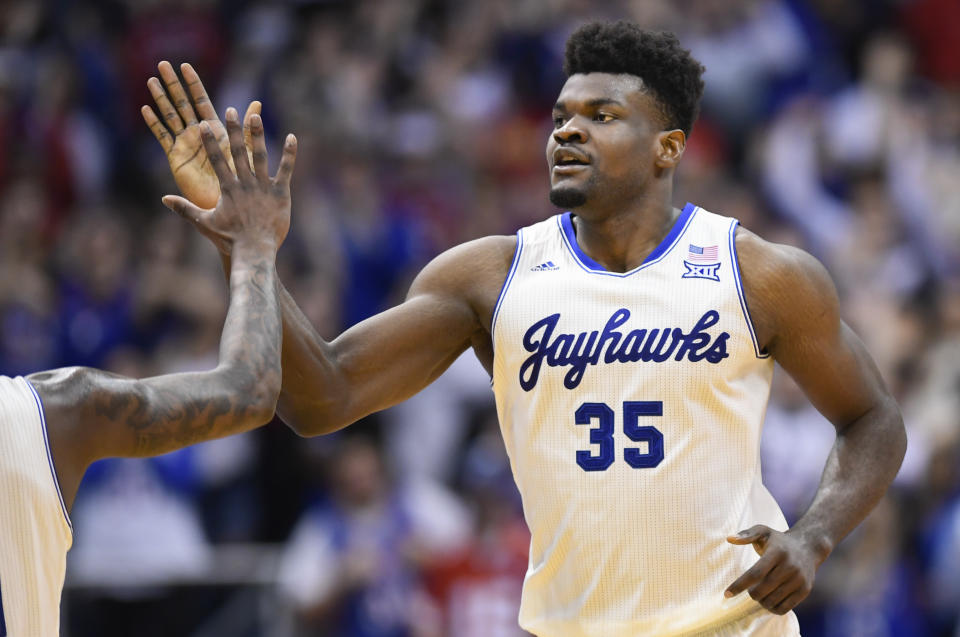 Kansas center Udoka Azubuike (35) is congratulated after a dunk against Texas during the second half of an NCAA college basketball game in Lawrence, Kan., Monday, Feb. 3, 2020. (AP Photo/Reed Hoffmann)