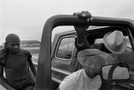 <p>Porter Lee Davis helps her critically ill husband, Mr. Will, from the cab of their pickup truck, 1986. (© Eugene Richards) </p>