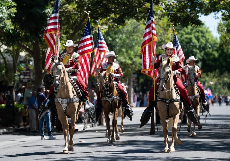 Members of the Merced County Sheriff Posse parade down Main Street during the annual downtown 4th of July parade in Turlock Calif., on Saturday, July 2, 2022.