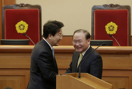 Chairman of the Judiciary Committee in the National Assembly Kwon Seong-Dong (L) meets with Lee Dong-heub, a lawyer representing impeached President Park Geun-hye, before the final hearing on whether to confirm the president's impeachment at the Constitutional Court in Seoul, South Korea, Febuary 27, 2017. REUTERS/Ahn Young-joon/Pool