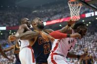 May 23, 2016; Toronto, Ontario, CAN; Cleveland Cavaliers forward LeBron James (23) collides with Toronto Raptors forward DeMarre Carroll (5) during the first quarter in game four of the Eastern conference finals of the NBA Playoffs at Air Canada Centre. Mandatory Credit: Nick Turchiaro-USA TODAY Sports