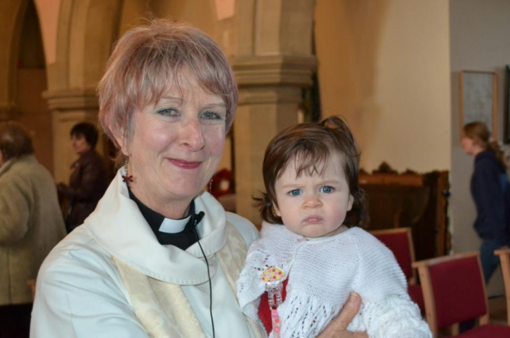 Reverend Wendy Callan poses with her granddaughter Cora, at her baptism. [Photo: Lydia Callan Mosedale]