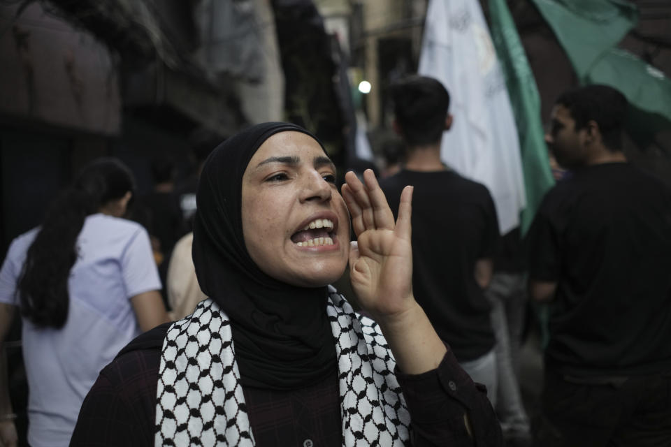 A Palestinian woman chants slogans against Israel during a protest called by Palestinian Islamic Jihad movement, in solidarity with the Palestinian people in Gaza, at the Palestinian refugee camp of Chatila in Beirut, Lebanon, Saturday, May 11, 2024. The Arabic on his headband reads: "No God but Allah and Muhammed is his messenger, top, Al-Quds Brigades, center, and The Islamic Jihad group in Palestine." (AP Photo/Hassan Ammar)