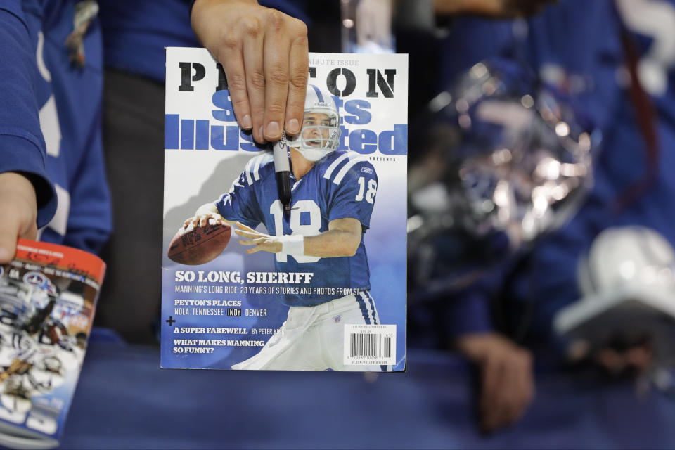 FILE - A fan waits for former Indianapolis Colts quarterback Peyton Manning to sign autographs before an NFL football game between the Tennessee Titans and the Indianapolis Colts, Nov. 20, 2016, in Indianapolis. Sports Illustrated is the latest media company damaged by being less than forthcoming about who or what is writing its stories. The website Futurism reported that the once-grand magazine used articles with “authors” who apparently don't exist, with photos generated by AI. The magazine denied claims that some articles themselves were AI-assisted, but has cut ties with a vendor it hired to produce the articles. (AP Photo/Darron Cummings, File)