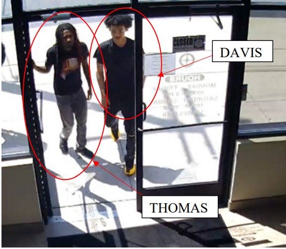 This screenshot captures Sheldon Thomas, left, and Ehmani Davis, entering the Action Impact gun shop during an initial failed attempt to purchase a weapon on May 29, 2022.