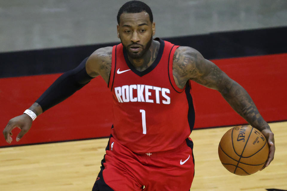 Jan 2, 2021; Houston, Texas, USA; John Wall #1 of the Houston Rockets controls the ball during the fourth quarter of a game against the Sacramento Kings at Toyota Center on January 02, 2021 in Houston, Texas.