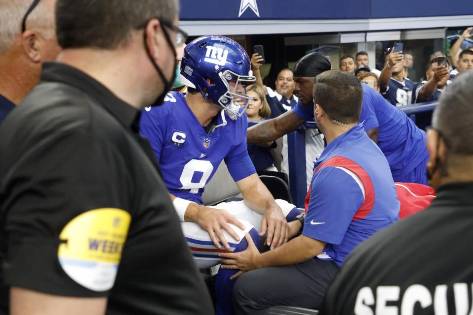 New York Giants' Daniel Jones (8) is carted off the field after suffering an unknown injury running the ball in the first half of an NFL football game against the Dallas Cowboys in Arlington, Texas, Sunday, Oct. 10, 2021. (AP Photo/Michael Ainsworth)