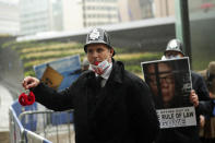 An anti Brexit protester blows a whistle as the Chancellor of the Duchy of Lancaster Michael Gove leaves the third meeting of the EU-UK Joint Committee outside EU headquarters in Brussels, Monday, Sept. 28, 2020. Chancellor of the Duchy of Lancaster Michael Gove on Monday met with Vice-President of the European Commission in charge of Inter-institutional relations and Foresight Maros Sefcovic, while EU chief Brexit negotiator Michel Barnier joined by videoconference. (AP Photo/Francisco Seco)