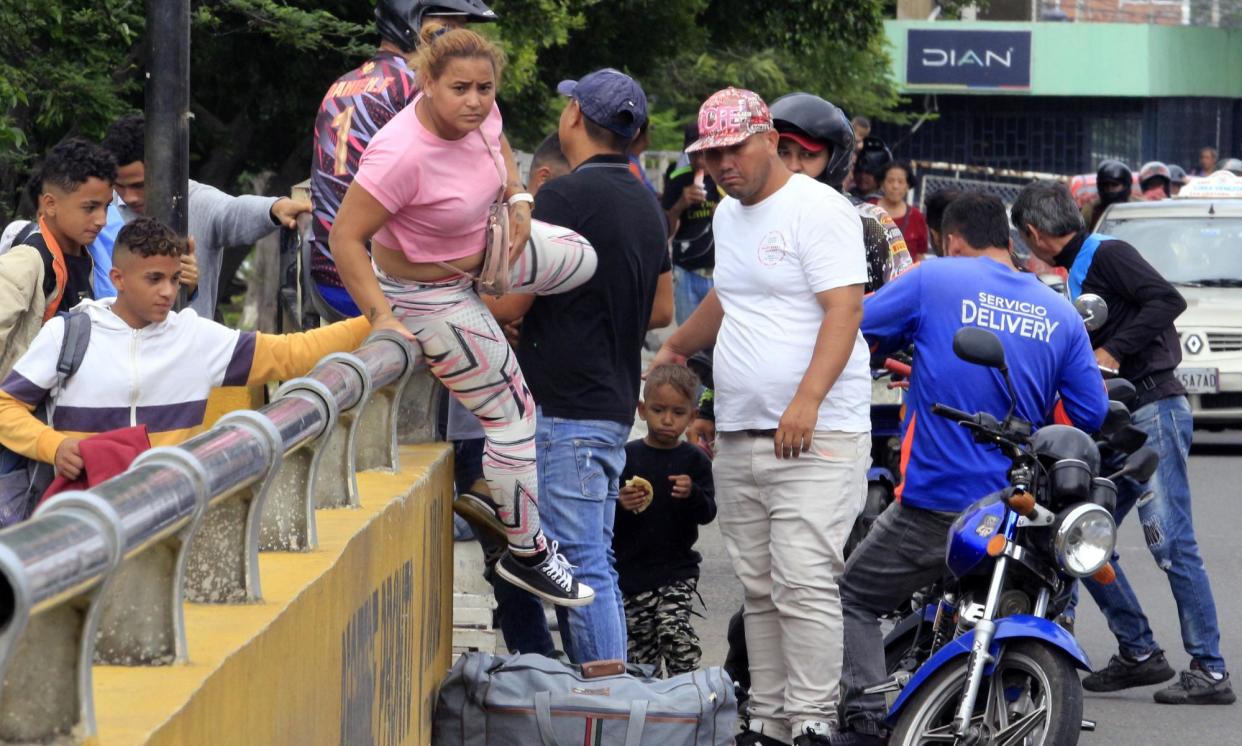 <span>Venezuelans walk across the Simón Bolívar Bridge in Villa del Rosario, Colombia, last week. More than 2.8 million Venezuelans have sought refuge in Colombia.</span><span>Photograph: Mario Caicedo/EPA</span>