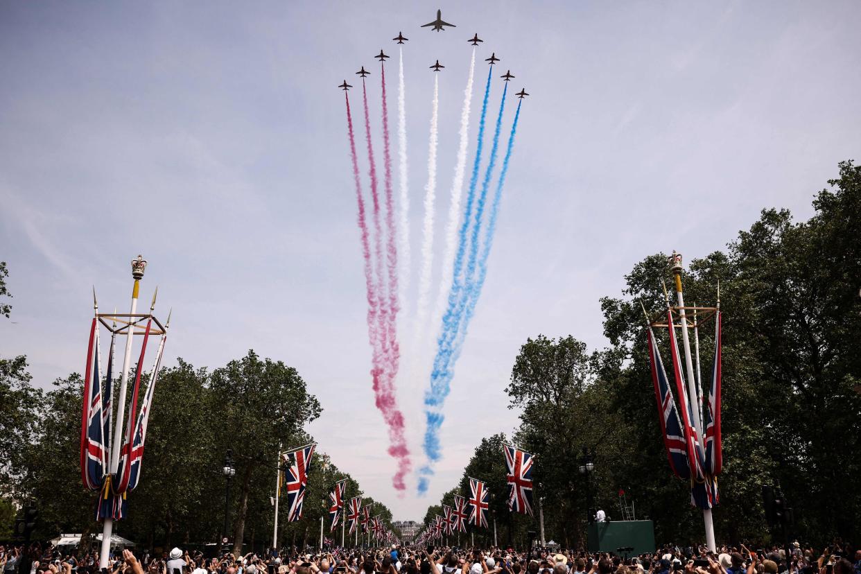 Members of the public cheer as they watch the Royal Air Force Aerobatic Team (AFP via Getty Images)