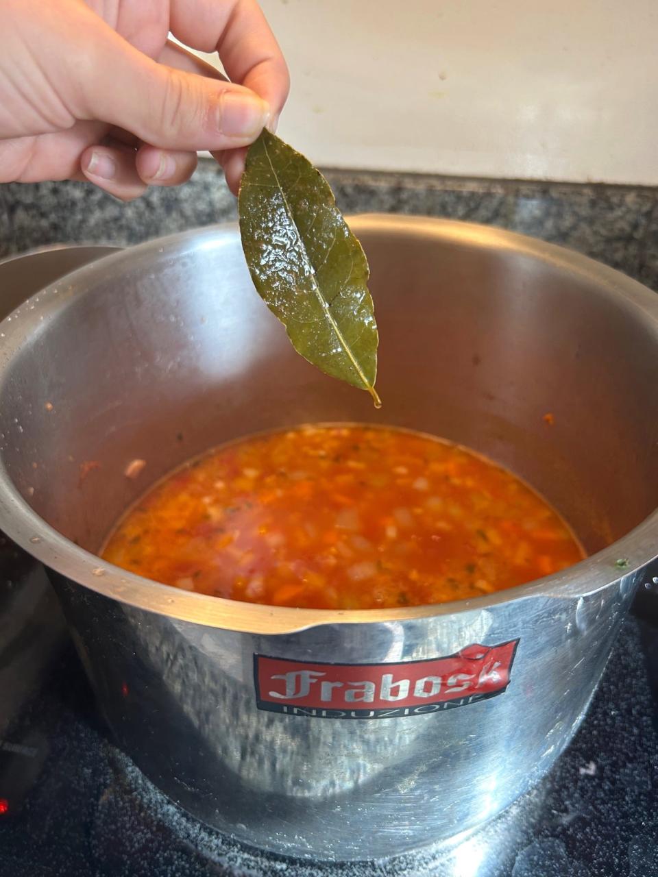 Taking out bay leaf for Ina Garten's winter minestrone soup