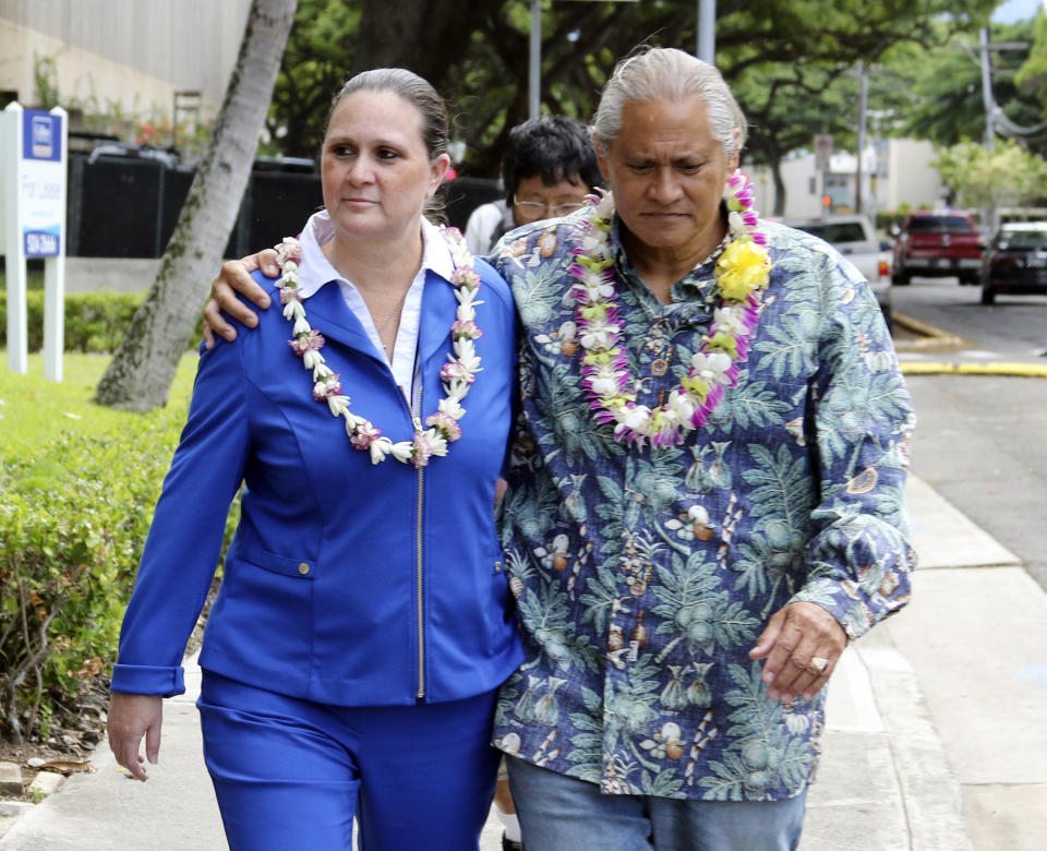 FILE - In this Oct. 20, 2017 file photo, former Honolulu Police Chief Louis Kealoha and his wife Katherine Keahola leave federal court in Honolulu. The city of Honolulu's chief legal officer has received a target letter linked to an ongoing federal corruption investigation. Mayor Kirk Caldwell says Corporation Counsel Donna Leong is taking a paid leave of absence, effective Monday, Jan. 14, 2019. (AP Photo/Caleb Jones, File)