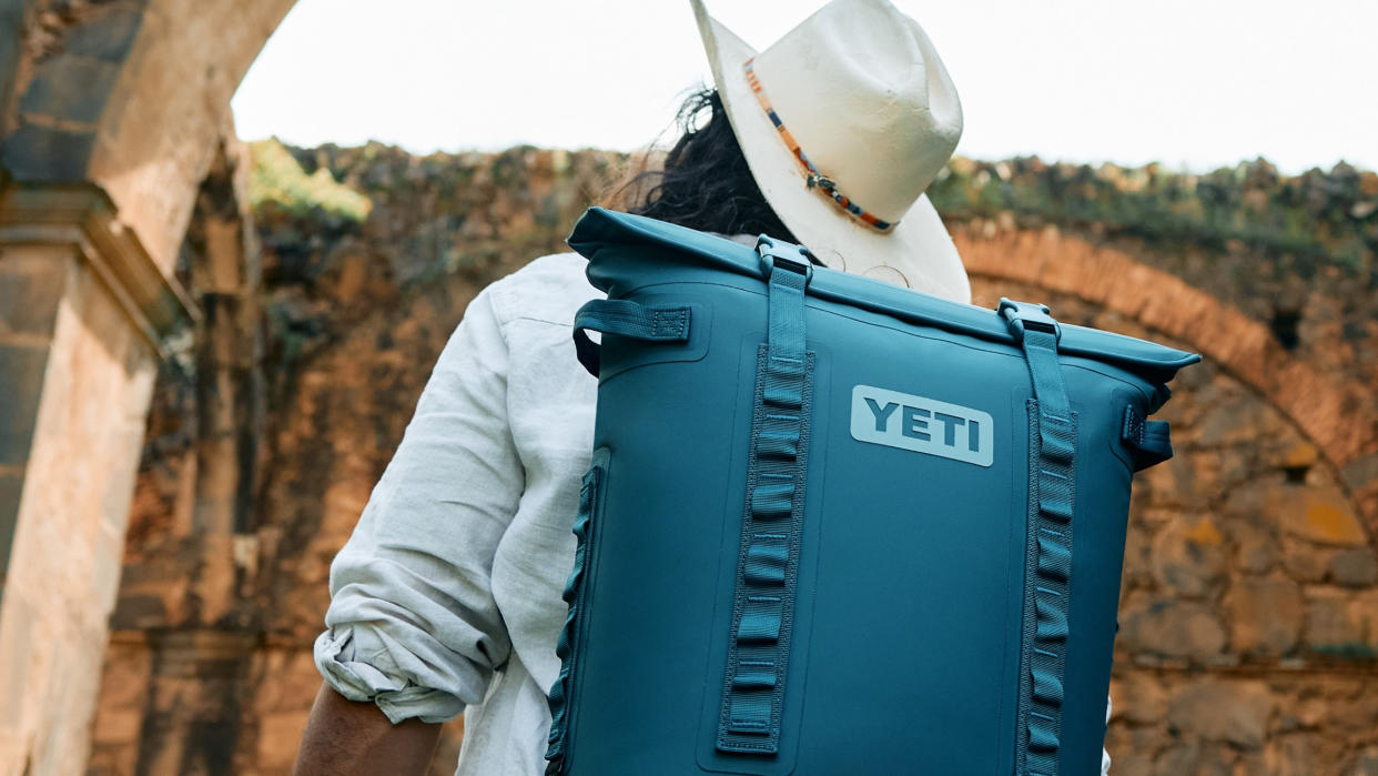  Man carrying Yeti backpack in Agave colorway. 