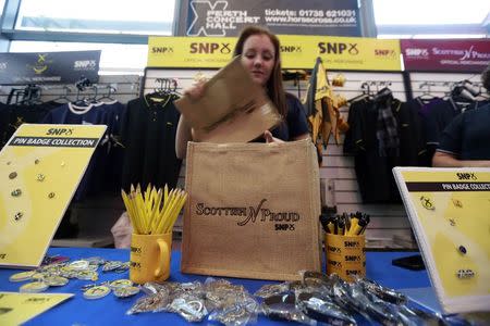 A woman looks at merchandise for sale at the Scottish Nationalist Party (SNP) annual party conference in Perth November 15, 2014. REUTERS/Cathal McNaughton